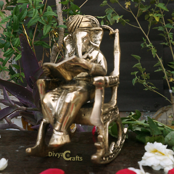 Barss Ganesha seated on a Rocking Chair reading Ramayan